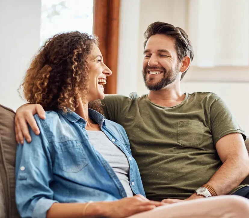 Smiling couple happy because they reduced their debt.